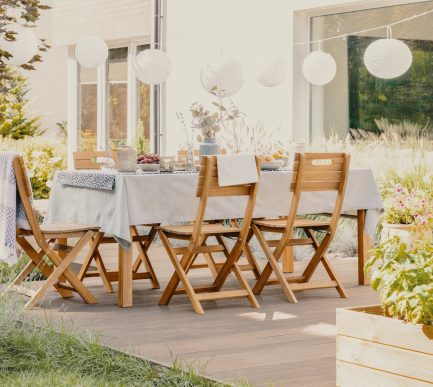 Outdoor dining room with wooden garden furniture set with table and chairs